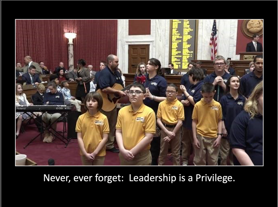 Image of students standing together with the words "Never, ever forget: Leadership is a priveledge." written underneath.